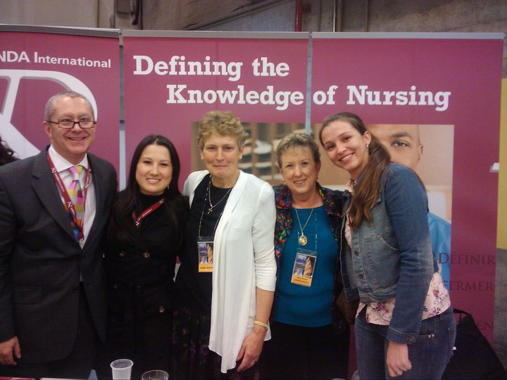INKA members in front of "defining the knowledge of nursing" sign