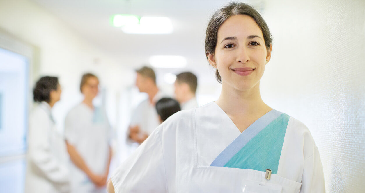 german nurse in foreground with other staff behind