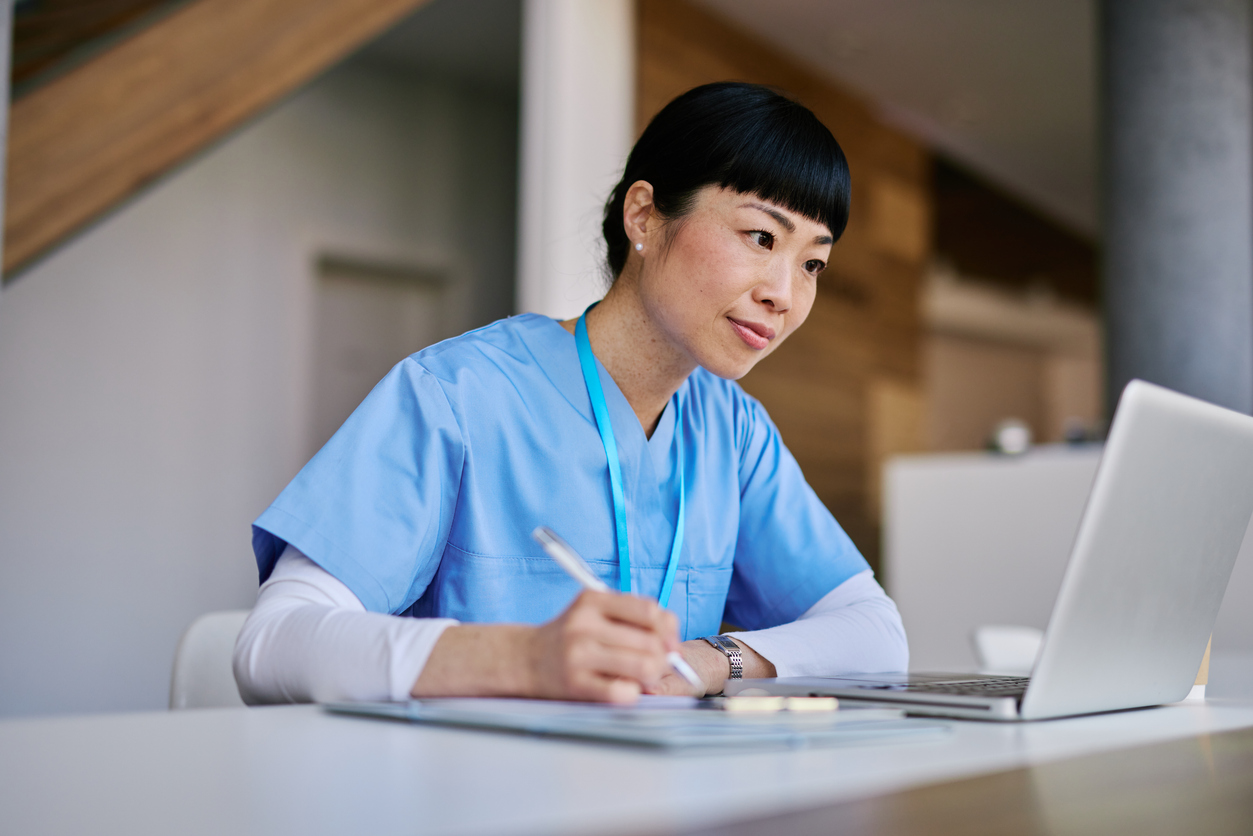 nurse watching webinar on computer