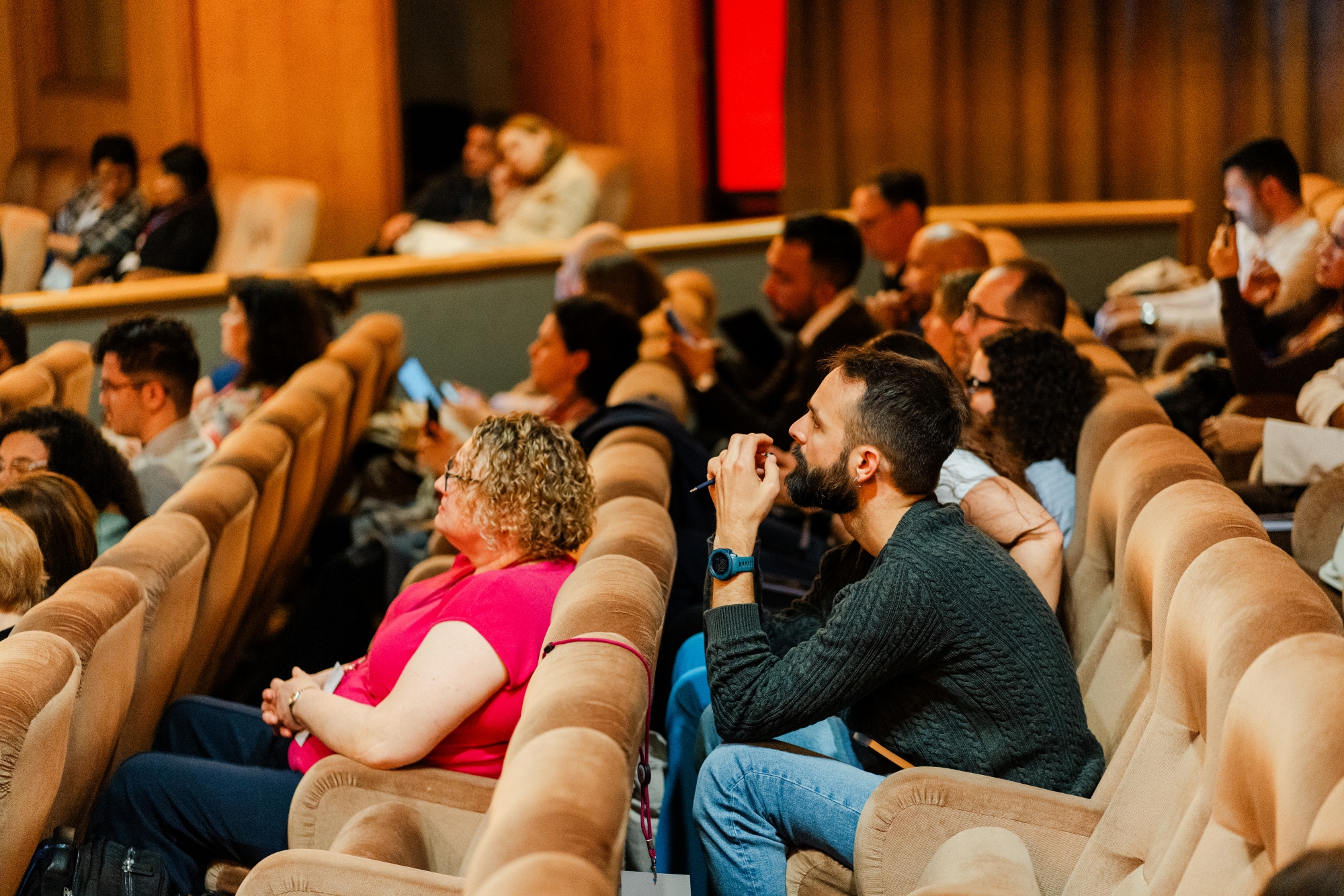 conference attendees intently listening to presentations
