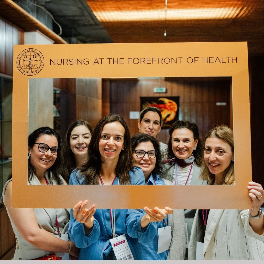 nurses holding banner saying "nursing at the forefront of health"