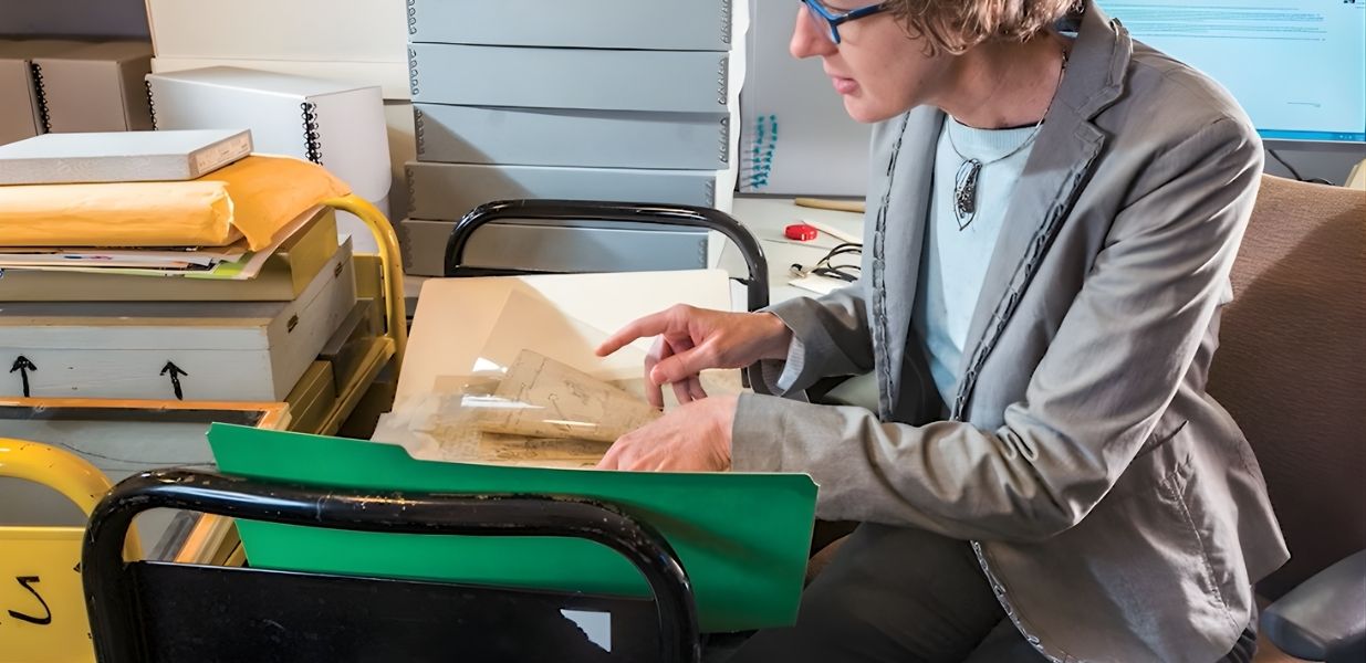 librarian looking through archive boxes