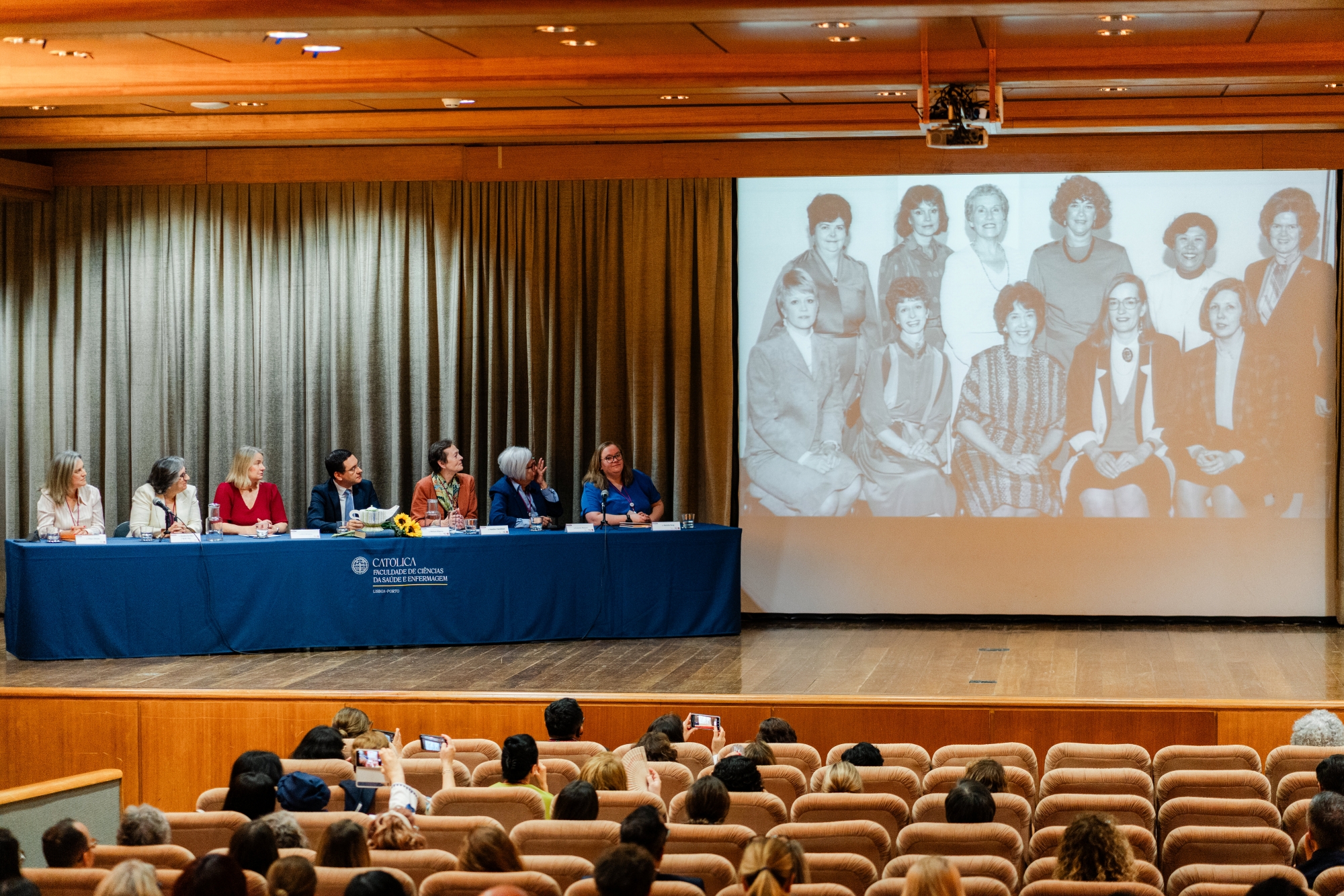 panel and audience looking at historical photo