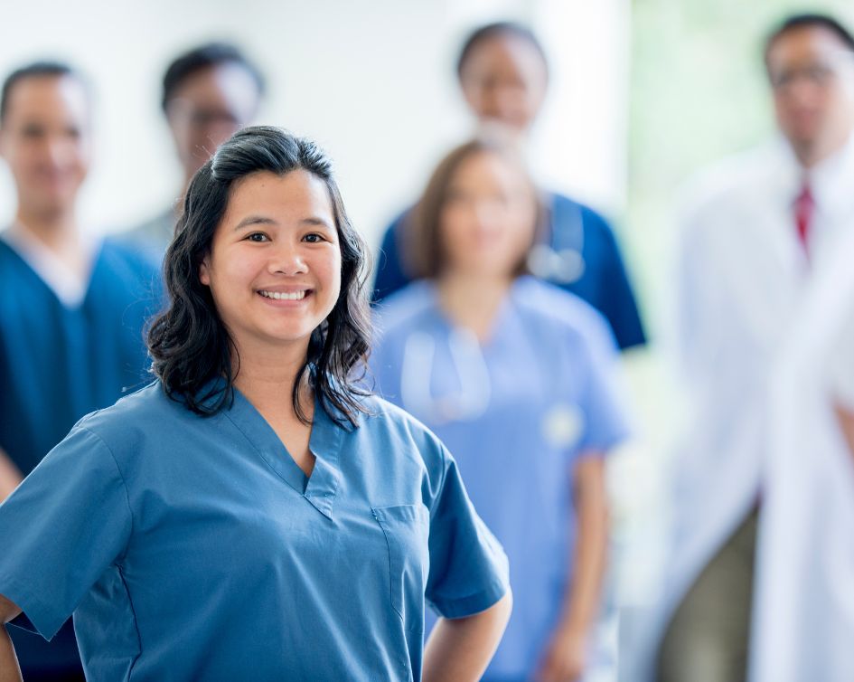 nurse in foreground with medical team in background