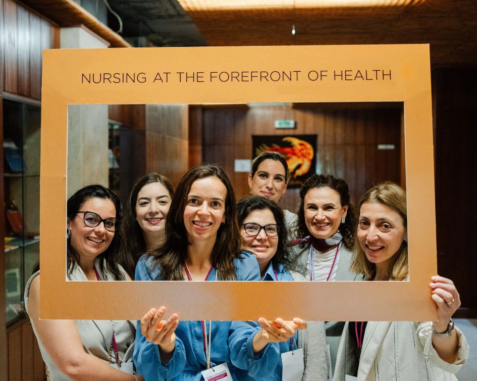 nurses holding banner saying "nursing at the forefront of health"