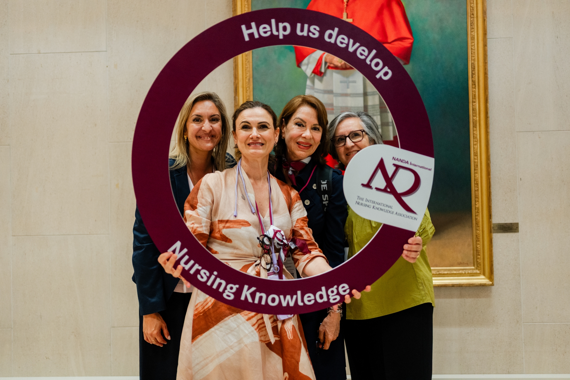 nurses holding "help us develop nursing knowledge" sign